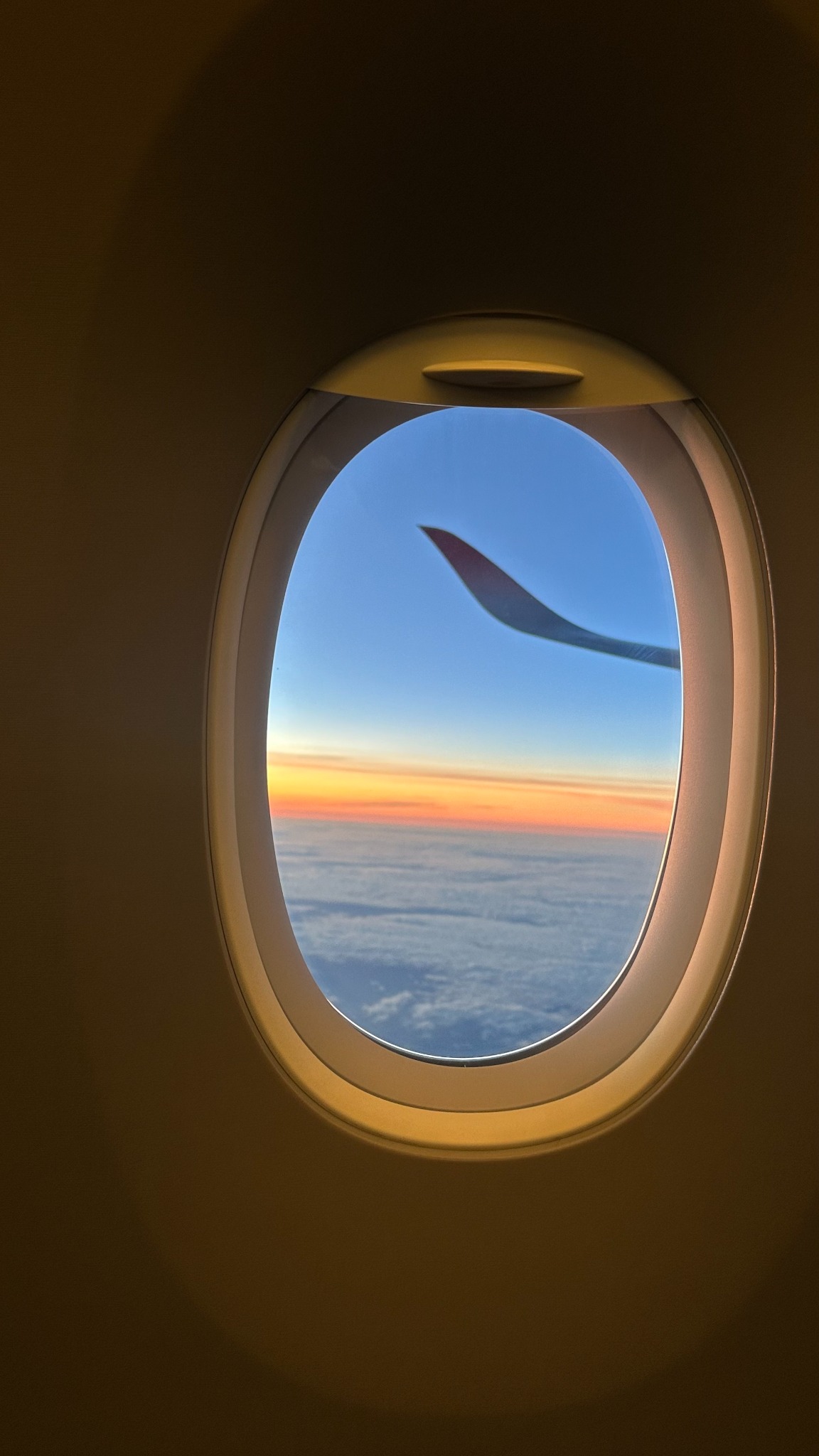 Sunset and clouds seen through an airplane window